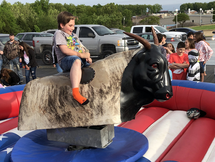 Kid riding mechanical bull